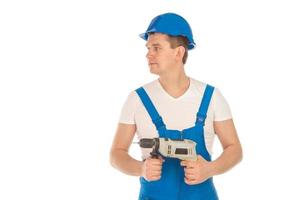 joven constructor mirando hacia otro lado con uniforme azul foto