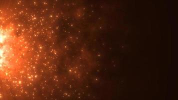 Abstract orange fiery flame bonfire of particles and sparks glowing beautiful magical on a dark background. Abstract background. Video in high quality 4k, motion design