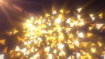Abstract flying small yellow luminous bright glass triangles particles fragments shiny energetic magical on a dark background. Abstract background. Video in high quality 4k, motion design