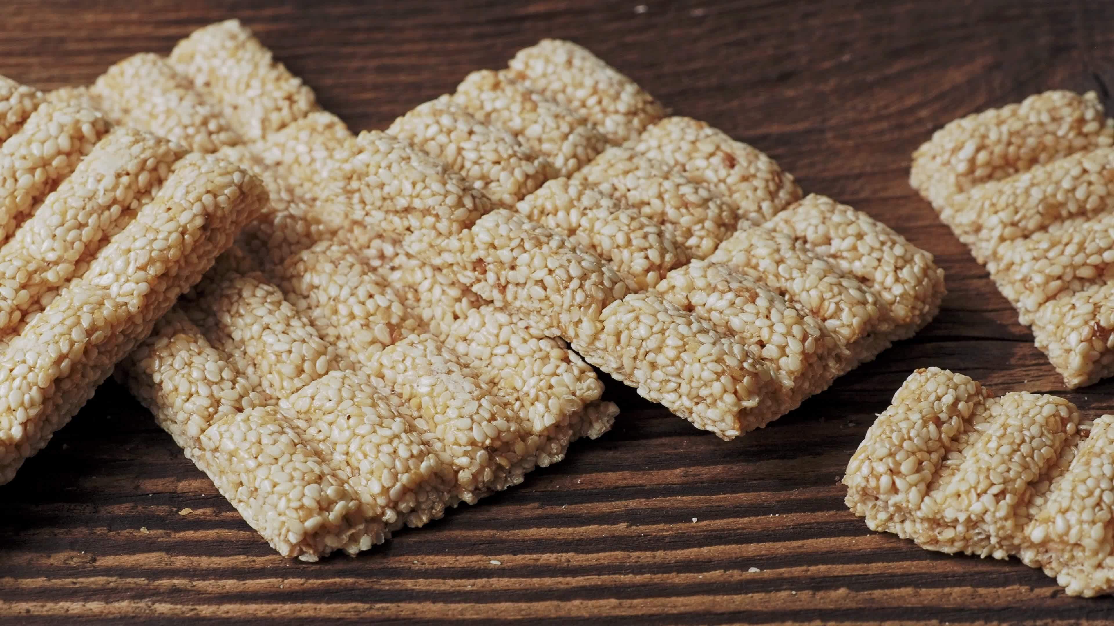 Sesame snack sweet. Sesame seed honey bar 16411948 Stock Video at Vecteezy