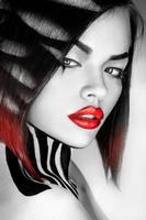 Desaturated portrait of sexy caucasian woman with red lips photo