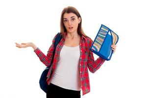 a young girl in a red Plaid Shirt and with a portfolio on the shoulders of surprise breeds hands photo