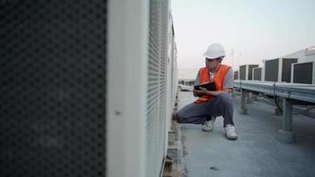 Factory engineers or staff checking the cooling system of the factory. Fore man records the condition of the compressor before  maintenance according maintenance plan. video