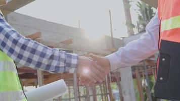 Construction worker team hands shaking greeting start up plan new project contract in office center at construction site, partnership and contractor concept video