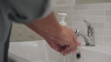 man washing his hands after handling an object to prevent infection with the virus. Washing your hands frequently reduces the risk of contracting the virus. clean is one method to prevent germs. video