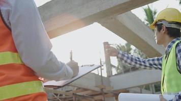 foreman is pointing out the structural details to the engineer. The inspection engineer is recording the details of the reinforced concrete structure at various locations. Concept inspector engineer. video