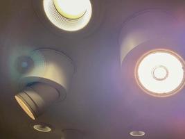 Bright luminous spotlights on the ceiling to illuminate the room photo