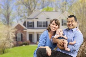 Happy Mixed Race Couple in Front of House photo