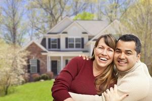 Happy Mixed Race Couple in Front of House photo