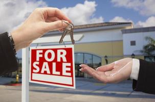 Agent Handing Over the Keys in Front of Business Office photo