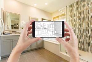 Hands Holding Smart Phone with Master Bathroom Drawing on Screen and Photo Behind