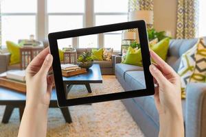 Female Hands Holding Computer Tablet In Room with Photo on Screen.