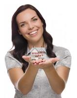 Pretty Mixed Race Woman Holding Small House Isolated on White photo