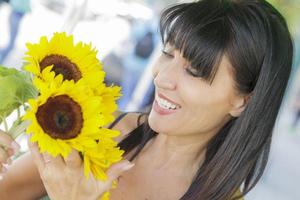 Pretty Italian Woman Looking at Sunflowers at Market photo