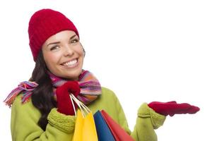 Mixed Race Woman Holding Shopping Bags Gesturing to Side photo