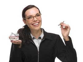 Mixed Race Female Presenting Keys and Holding a Small House photo