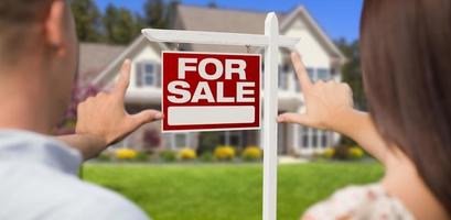 For Sale Sign, House and Military Couple Framing Hands photo