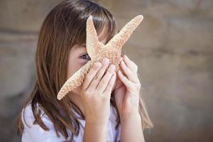 Young Girl Playing with Starfish photo