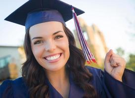 Happy Graduating Mixed Race Woman In Cap and Gown photo