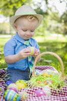 Cute Little Boy Enjoying His Easter Eggs Outside in Park photo