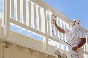 House Painter Spray Painting A Deck of A Home photo