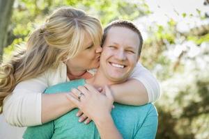 Young Attractive Couple Hugging in the Park photo