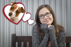 Daydreaming Girl Next To Floating Hearts with Puppy Within photo