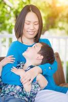 Outdoor Portrait of Chinese Mother with Her Mixed Race Chinese and Caucasian Young Boy photo