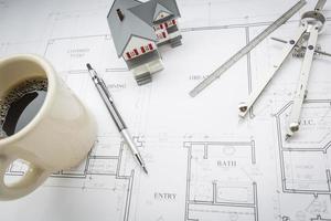 Home, Coffee, Pencil, Ruler and Compass Resting on House Plans photo