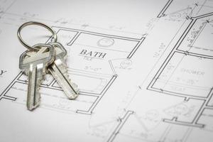 Set Of New House Keys Resting On House Plans photo