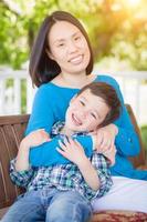 Outdoor Portrait of Chinese Mother with Her Mixed Race Chinese and Caucasian Young Boy photo