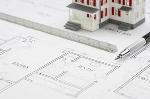 Model Home, Engineer Pencil and Ruler Resting On House Plans photo