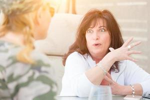 Two Female Friends Enjoying Conversation Outside photo