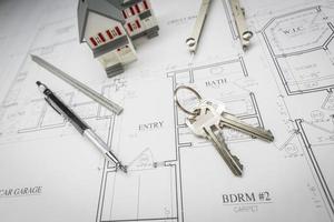Home, Pencil, Compass, Ruler and Keys Resting On House Plans photo