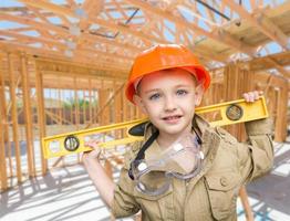 Young Boy Contractor With Level On Site Inside New Home Construction Framing. photo