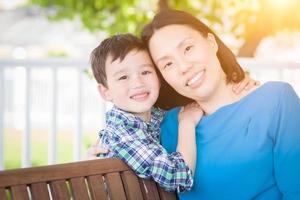 Outdoor Portrait of Chinese Mother with Her Mixed Race Chinese and Caucasian Young Boy photo