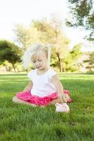 Little Girl Having Fun with Her Piggy Bank Outside photo