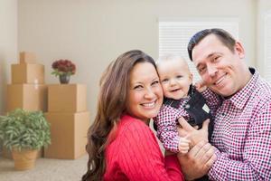 Caucasian Family with Baby In Room with Moving Boxes photo