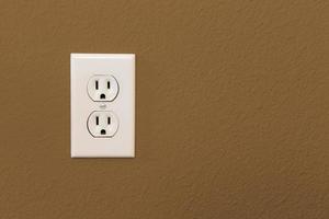 Electrical Sockets In Colorful Brown Wall photo