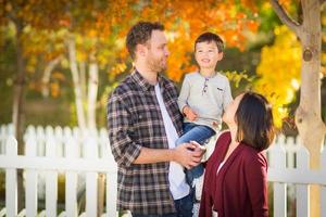 Outdoor Portrait of Mixed Race Chinese and Caucasian Parents and Child. photo