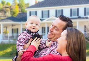 Baby Having Fun With Mother and Father Out Front photo