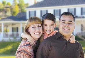 Happy Mixed Race Young Family in Front of House photo