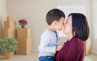 Mixed Race Chinese Mother and Child in Empty Room with Packed Moving Boxes photo