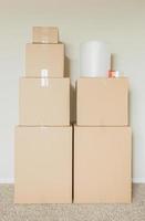 Variety of Packed Moving Boxes In Empty Room photo