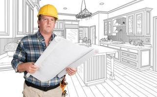 Male Contractor With House Plans Wearing Hard Hat In Front of Custom Kitchen Drawing photo