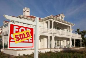 Sold Home For Sale Sign in Front of New House photo