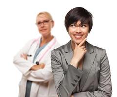 Young Multiethnic Woman and Female Doctor photo