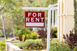 Red For Rent Real Estate Sign in Front House photo