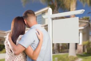 Blank Real Estate Sign and Military Couple Looking at House photo