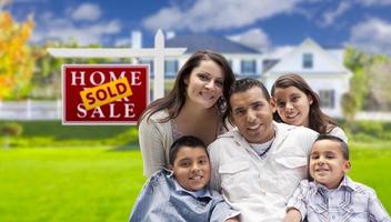 Hispanic Family in Front of Sold Real Estate Sign, House photo